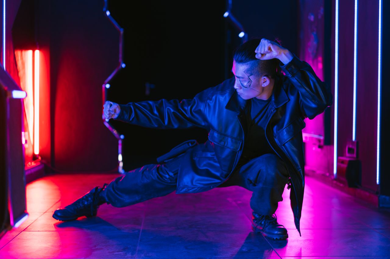 A man in a cyberpunk setting striking a dynamic pose with vibrant neon lighting.